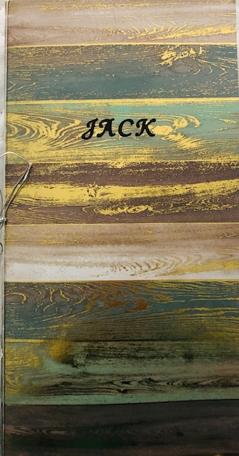 The pages of my chapbook are made from cardboard/construction like paper purchased from the craft store Michaels. The front cover includes the title “Jack”, placed on a metallic like design paper.